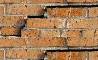 Brick wall with serious structural damage in {city}, {state}